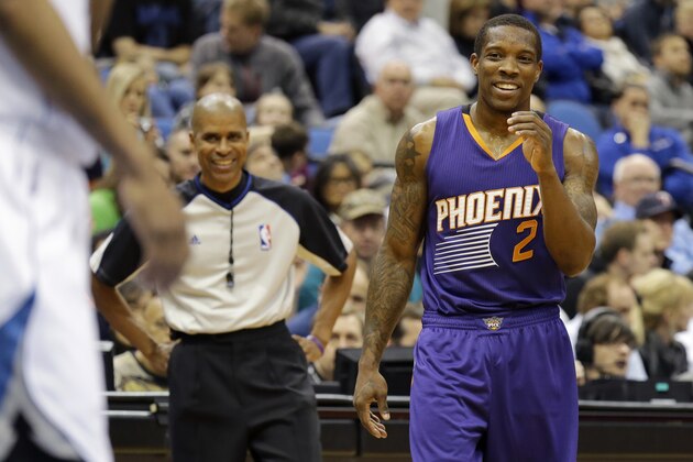 Phoenix Suns guard Eric Bledsoe (2) laughs after talking with referee Sean Corbin, left, during the third quarter of an NBA basketball game against the Minnesota Timberwolves in Minneapolis, Sunday, March 23, 2014. The Suns won 127-120. (AP Photo/Ann Heisenfelt)