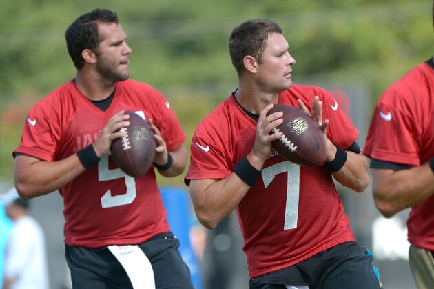 Jacksonville Jaguars quarterbacks Chad Henne (7) and Blake Bortles (5) drop back to pass during NFL football training camp in Jacksonville, Fla., Friday, July 25, 2014.(AP Photo/Phelan M. Ebenhack)