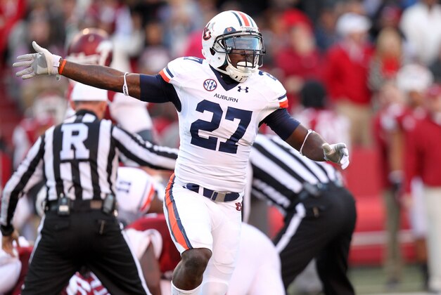 Nov 2, 2013; Fayetteville, AR, USA; Auburn Tigers defensive back Robenson Therezie (27) celebrates after a Tigers fumble recovery in the first quarter against the Arkansas Razorbacks at Donald W. Reynolds Razorback Stadium. Mandatory Credit: Nelson Chenault-USA TODAY Sports