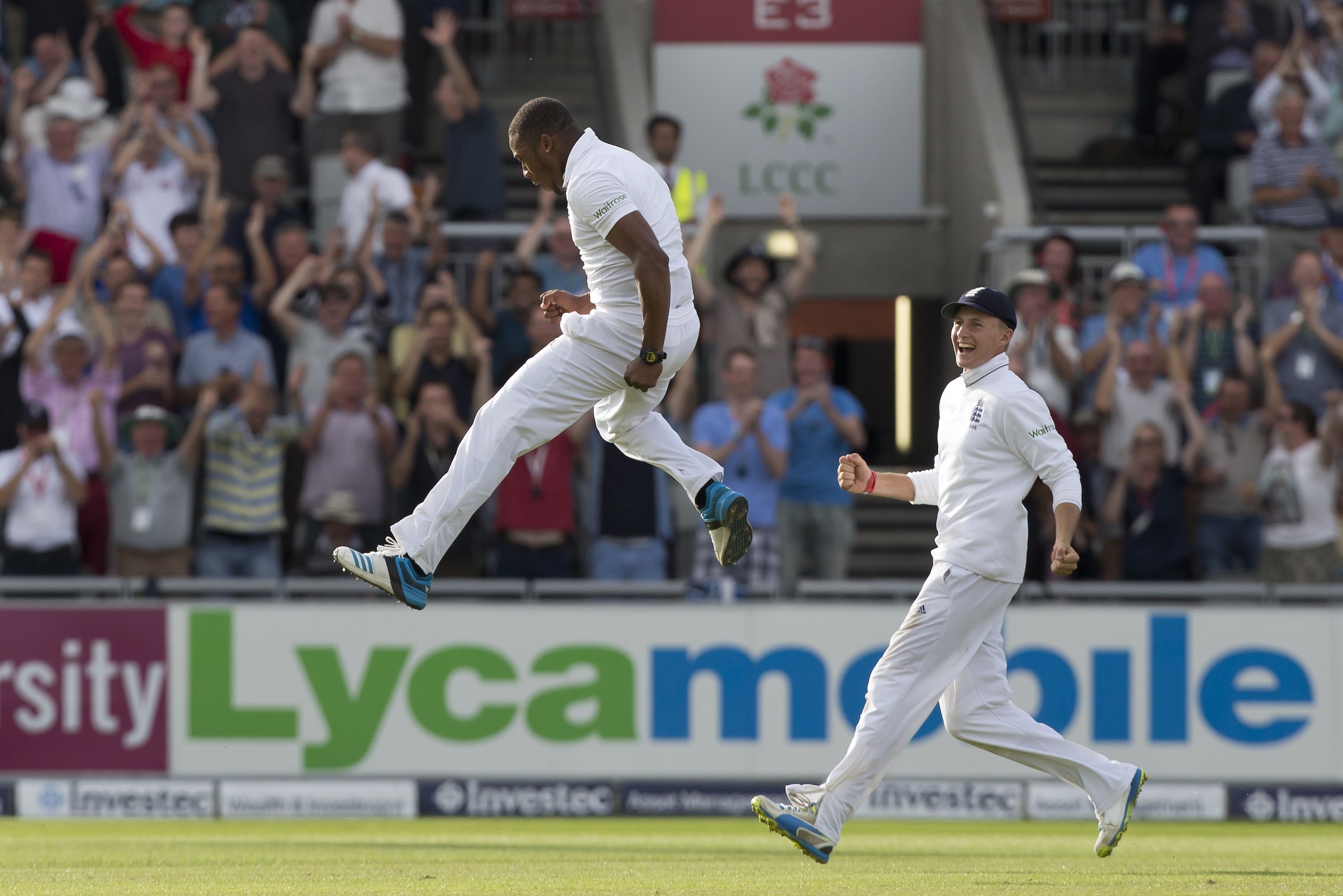 England's Chris Jordan, center, celebrates after taking India's last wicket, that of Pankaj Singh, bowled first ball, at Old Trafford cricket ground on the third day of the fourth test match of their five match series against England, in Manchester, England, Saturday, Aug. 9, 2014. England won the game by an innings and 54 runs. (AP Photo/Jon Super)
