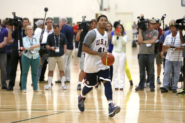 Reporters and photographers wait for Derrick Rose to finish his individual workout after a practice of the men's U.S. National basketball team Thursday, Aug. 14, 2014, in Chicago. The U.S. team will face the Brazilian team in an exhibition game at the United Center in Chicago Saturday. (AP Photo/Charles Rex Arbogast)