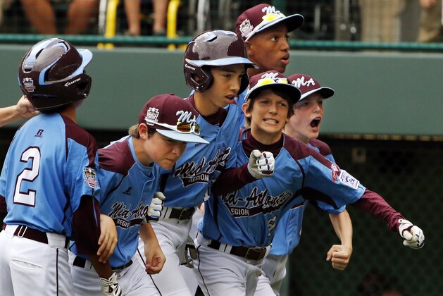 Philadelphia's Jared Sprague-Lott, center, celebrates with teammates as he returns to the dugout after hitting a three-run home run off Nashville pitcher Blake Money during the first inning of a baseball game in U.S. pool play at the Little League World Series baseball tournament in South Williamsport, Pa., Friday, Aug. 15, 2014. Philadelphia won 4-0. (AP Photo/Gene J. Puskar)