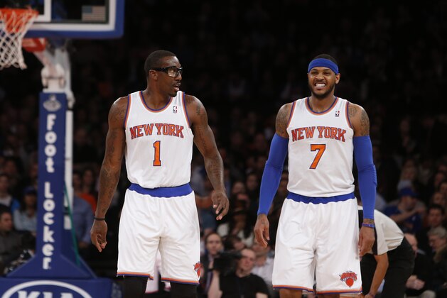 New York Knicks' Amar'e Stoudemire (1) talks to teammate Carmelo Anthony (7) as they walk up the court during the first half of an NBA basketball game against the Dallas Mavericks, Monday, Feb. 24, 2014, in New York.  Dallas won 110-108. (AP Photo/Jason DeCrow)