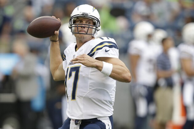 San Diego Chargers quarterback Philip Rivers passes during warmups before a preseason NFL football game against the Seattle Seahawks, Friday, Aug. 15, 2014, in Seattle. (AP Photo/Stephen Brashear)