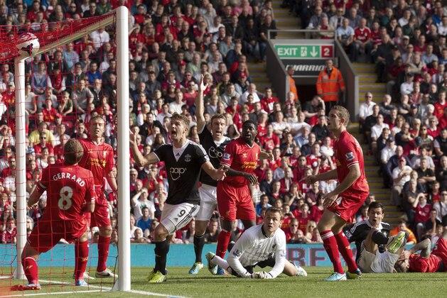Southampton's Dejan Lovren, bottom right, scores against Liverpool during their English Premier League soccer match at Anfield Stadium, Liverpool, England, Saturday Sept. 21, 2013. (AP Photo/Jon Super)