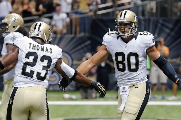 New Orleans Saints tight end Jimmy Graham (80) celebrate his touchdown reception with running back Pierre Thomas (23) in the first half of a NFL football game in New Orleans, Friday, Aug. 15, 2014. (AP Photo/Bill Haber)