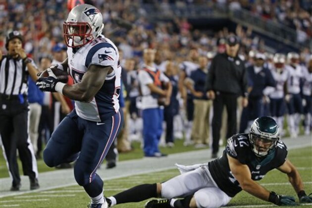 New England Patriots running back Jonas Gray, left, runs past Philadelphia Eagles free safety Chris Maragos (42) in the second half of an NFL preseason football game Friday, Aug. 15, 2014, in Foxborough, Mass. (AP Photo/Elise Amendola)