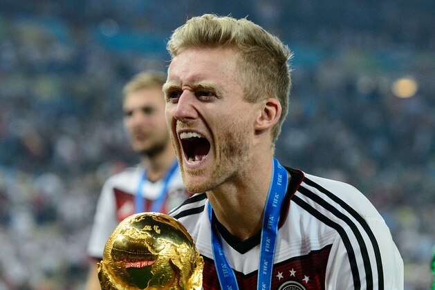 RIO DE JANEIRO, BRAZIL - JULY 13:  Andre Schuerrle celebrates with the World Cup trophy after defeating Argentina 1-0 in extra time during the 2014 FIFA World Cup Brazil Final match between Germany and Argentina at Maracana on July 13, 2014 in Rio de Janeiro, Brazil.  (Photo by Matthias Hangst/Getty Images)