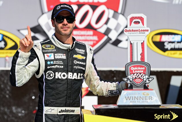 BROOKLYN, MI - JUNE 15:  Jimmie Johnson, driver of the #48 Lowe's/Kobalt Tools Chevrolet, poses with the trophy after winning the NASCAR Sprint Cup Series Quicken Loans 400 at Michigan International Speedway on June 15, 2014 in Brooklyn, Michigan.  (Photo by Patrick Smith/Getty Images)