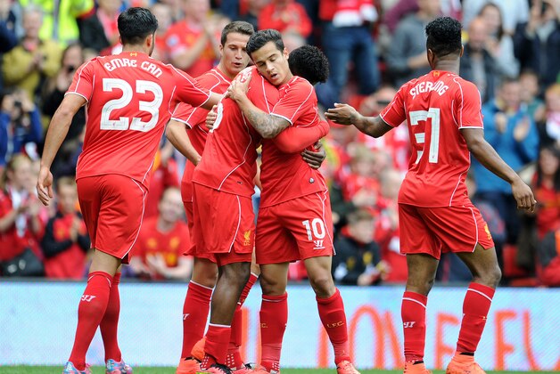 LIVERPOOL, ENGLAND - AUGUST 10:  Daniel Sturridge (C) of Liverpool celebrates with team-mate Philippe Coutinho after he scores the first goal of the game for his side during the Pre Season Friendly match between Liverpool and Borussia Dortmund at Anfield on August 10, 2014 in Liverpool, England. (Photo by Clint Hughes/Getty Images)