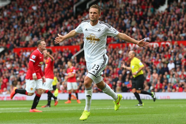 MANCHESTER, ENGLAND - AUGUST 16:  Gylfi Sigurdsson of Swansea City celebrates scoring his team's second goal during the Barclays Premier League match between Manchester United and Swansea City at Old Trafford on August 16, 2014 in Manchester, England.  (Photo by Alex Livesey/Getty Images)