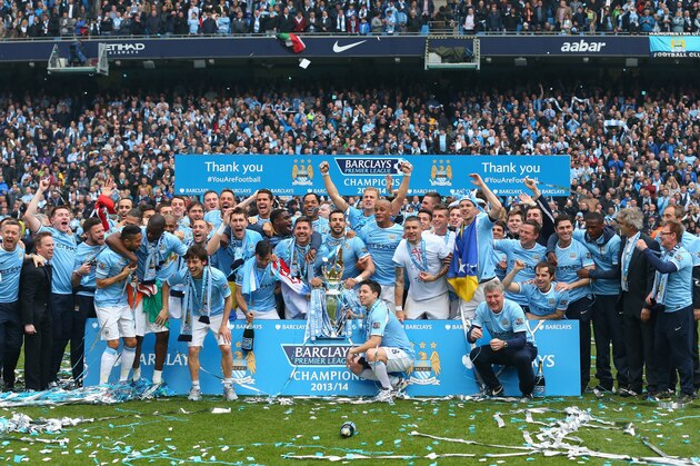 MANCHESTER, ENGLAND - MAY 11:  The Manchester City players celebrate with the Premier League trophy at the end of the Barclays Premier League match between Manchester City and West Ham United at the Etihad Stadium on May 11, 2014 in Manchester, England.  (Photo by Alex Livesey/Getty Images)