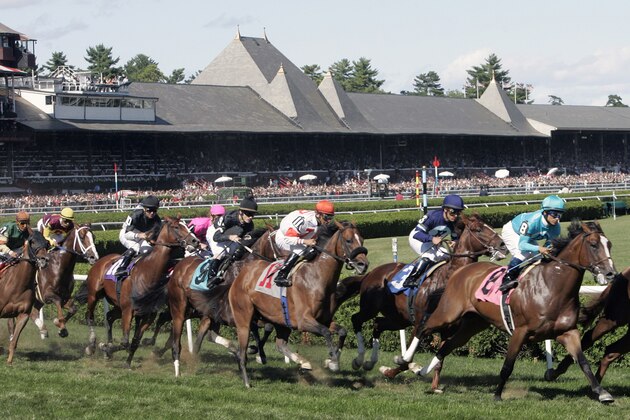 A horse race is run on a turf track at the Saratoga Race Course in Saratoga Springs, N.Y., Saturday, Aug. 18, 2007. (AP Photo/Mike Groll)