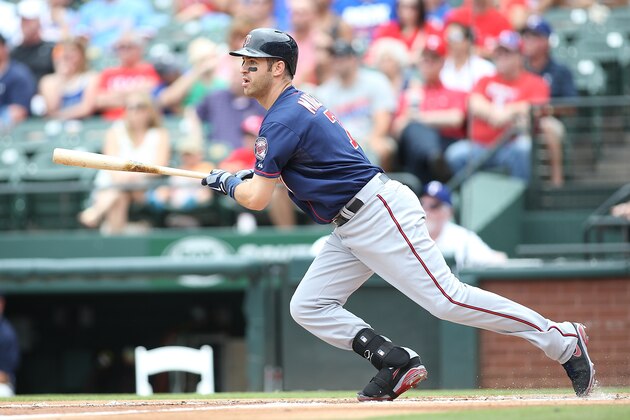 ARLINGTON, TX - JUNE 28: Joe Mauer #7 of the Minnesota Twins makes a base hit in the first inning against the Texas Rangers at Globe Life Park in Arlington on June 28, 2014 in Arlington, Texas.  (Photo by Rick Yeatts/Getty Images)