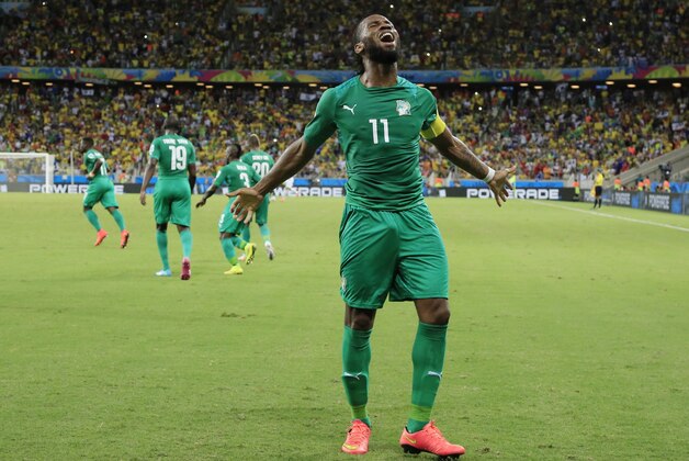 Ivory Coast's Didier Drogba (11) celebrates after Wilfried Bony scored his side's first goal against Greece's goalkeeper Panagiotis Glykos during the group C World Cup soccer match between Greece and Ivory Coast at the Arena Castelao in Fortaleza, Brazil, Tuesday, June 24, 2014. (AP Photo/Bernat Armangue)