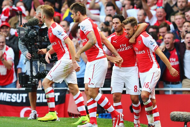 LONDON, ENGLAND - AUGUST 16: Aaron Ramsey (R) of Arsenal celebrates his goal with team mate Mikel Arteta during the Barclays Premier League match between Arsenal and Crystal Palace at Emirates Stadium on August 16, 2014 in London, England.  (Photo by Clive Mason/Getty Images)