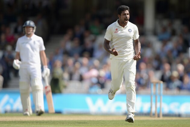 LONDON, ENGLAND - AUGUST 16:  Varun Aaron of India celebrates dismissing England captain Alastair Cook during day two of 5th Investec Test match between England and India at The Kia Oval on August 16, 2014 in London, England.  (Photo by Gareth Copley/Getty Images)