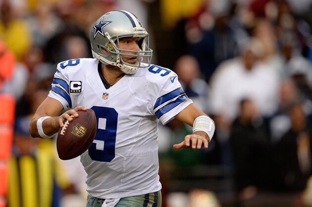 LANDOVER, MD - DECEMBER 22:  Quarterback Tony Romo #9 of the Dallas Cowboys scrambles with the ball in the second half during an NFL game against the Washington Redskins at FedExField on December 22, 2013 in Landover, Maryland.  (Photo by Patrick McDermott/Getty Images)