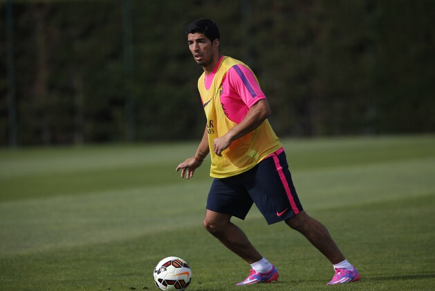 Luis Suarez, of Uruguay, trains during a training session at the Sports Center FC Barcelona Joan Gamper in San Joan Despi, in Barcelona, Spain, Friday, August 15, 2014. Luis Suarez trained with his Barcelona teammates on Friday after his ban for biting an opponent at the World Cup was softened but not shortened.The Court of Arbitration for Sport ruled Thursday that the Uruguay forward, who recently left Liverpool for Barcelona, deserves his four-month ban from playing official matches for both his club and his country. (AP Photo/Emilio Morenatti )