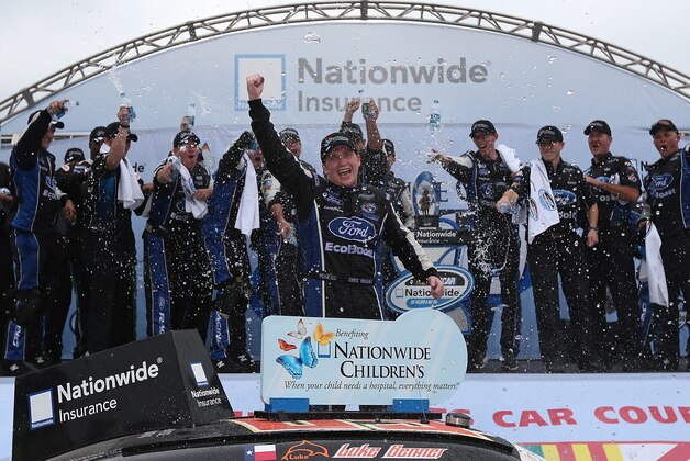 LEXINGTON, OH - AUGUST 16:  Chris Buescher, driver of the #60 Nationwide Children's Hospital Ford Mustang Ford, celebrates in victory lane after winning the Nationwide Children's Hospital 200 at Mid-Ohio Sports Car Course on August 16, 2014 in Lexington, Ohio.  (Photo by Sarah Glenn/Getty Images)