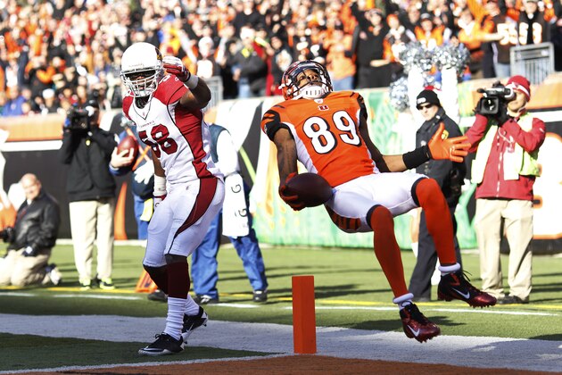 CINCINNATI, OH - DECEMBER 24: Jerome Simpson #89 of the Cincinnati Bengals jumps over Daryl Washington #58 of the Arizona Cardinals for a 19-yard touchdown during first half action at Paul Brown Stadium on December 24, 2011 in Cincinnati, Ohio. (Photo by Joe Robbins/Getty Images)