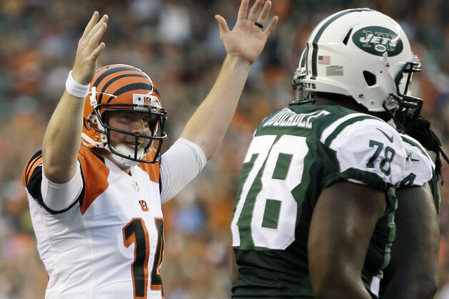 Cincinnati Bengals quarterback Andy Dalton (14) signals a touchdown after Giovani Bernard scored on a one yard run in the first half of an NFL preseason football game against the New York Jets, Saturday, Aug. 16, 2014, in Cincinnati. (AP Photo/Tony Tribble)