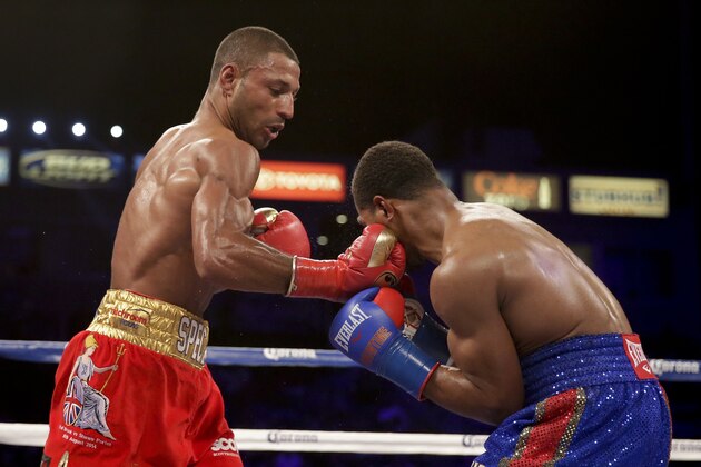 Kell Brook, left, hits Shawn Porter during their IBF welterweight title boxing bout Saturday, Aug. 16, 2014, in Carson, Calif. (AP Photo/Chris Carlson)