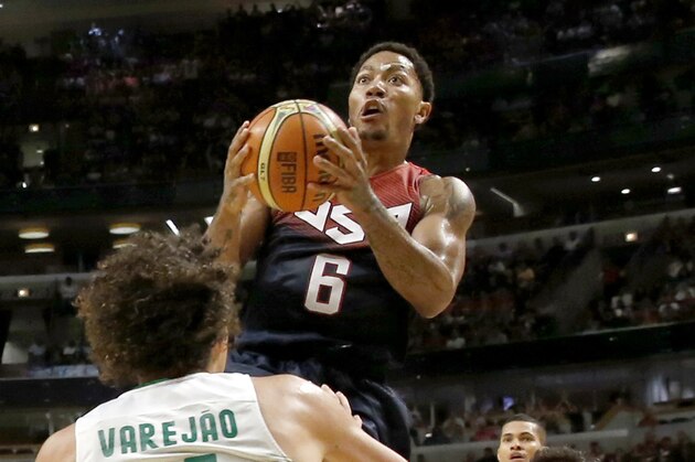 United States' Derrick Rose (6), of the Chicago Bulls, drives between Brazil's Anderson Varejao (11), of the Cleveland Cavaliers, and Brazil's Raulzinho Neto (5) during the second half of an exhibition basketball game Saturday, Aug. 16, 2014, in Chicago. The United States won 95-78. (AP Photo/Charles Rex Arbogast)