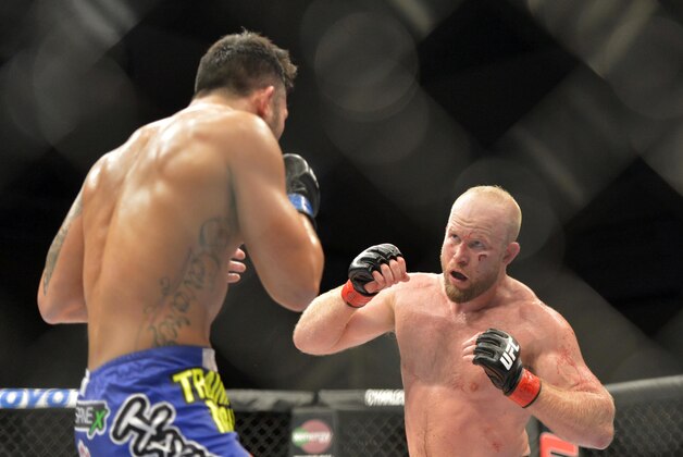 Aug 16, 2014; Bangor, ME, USA; Tim Boetsch (red gloves) fights Brad Tavares (blue gloves) during a middleweight  bout in UFC Fight Night 47 at Cross Insurance Center. Mandatory Credit: Gregory J. Fisher-USA TODAY Sports