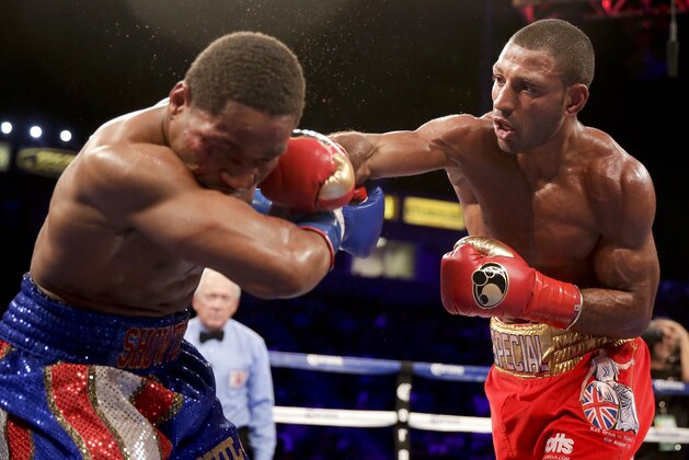 Shawn Porter, left, gets hit by Kell Brook during their IBF welterweight title boxing bout Saturday, Aug. 16, 2014, in Carson, Calif. (AP Photo/Chris Carlson)