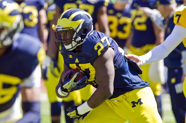 Michigan running back Derrick Green (27) takes a handoff and rushes during the NCAA college football team's annual spring game on Saturday, April 5, 2014, in Ann Arbor, Mich. (AP Photo/Tony Ding)