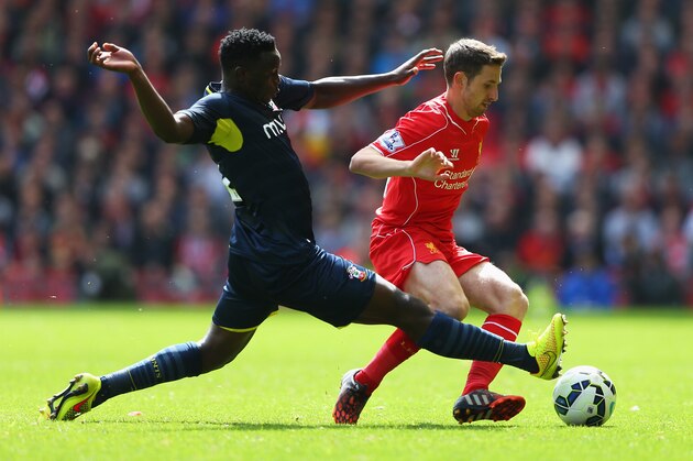LIVERPOOL, ENGLAND - AUGUST 17: Joe Allen of Liverpool is tackled by Victor Wanyama of Southampton during the Barclays Premier League match between Liverpool and Southampton at Anfield on August 17, 2014 in Liverpool, England.  (Photo by Alex Livesey/Getty Images)