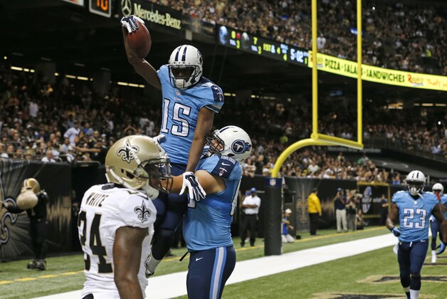 Tennessee Titans wide receiver Justin Hunter (15) pulls in a touchdown reception over New Orleans Saints cornerback Corey White (24) in the first half of an NFL preseason football game in New Orleans, Friday, Aug. 15, 2014. (AP Photo/Bill Haber)