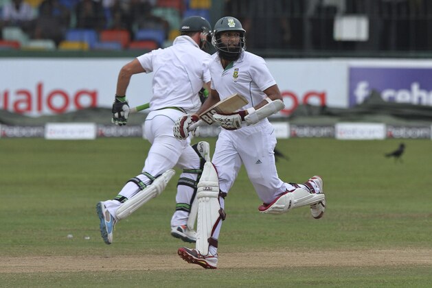South African batsmen Hashim Amla, front, and Faf du Plessis run between the wickets during the fifth day of the second test cricket match between South Africa and Sri Lanka in Colombo, Sri Lanka, Monday, July 28, 2014. South Africa won the two-test series 1-0 after the second test was drawn Monday.(AP Photo/Sanka Gayashan)