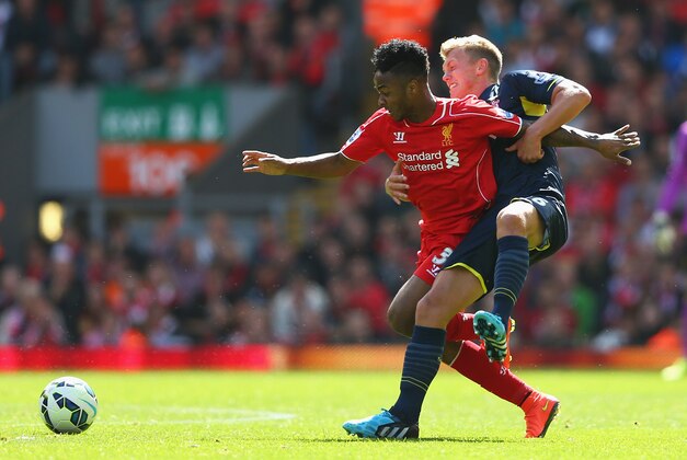 LIVERPOOL, ENGLAND - AUGUST 17: Raheem Sterling of Liverpool is challenged by James Ward-Prowse of Southampton during the Barclays Premier League match between Liverpool and Southampton at Anfield on August 17, 2014 in Liverpool, England.  (Photo by Alex Livesey/Getty Images)