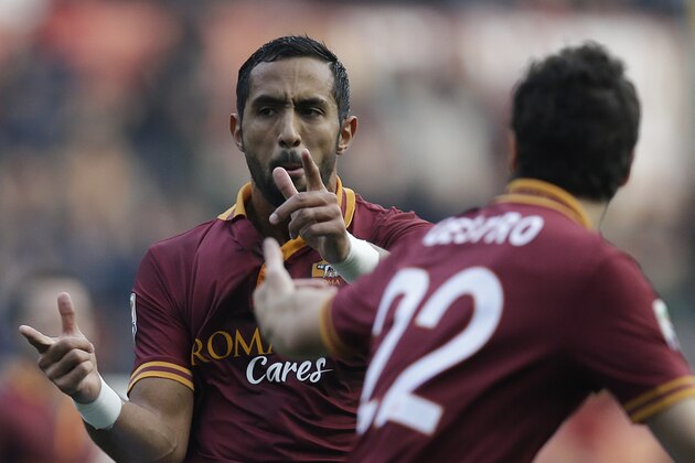 AS Roma's Mehdi Benatia, left, celebrates with teammate Mattia Destro after scoring during a Serie A soccer match against Catania in Rome's Olympic Stadium, Sunday, Dec. 22, 2013. (AP Photo/Gregorio Borgia)