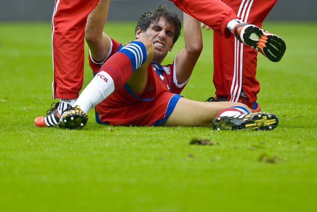 Munich's Javier Martinez lies injured on the pitch during the German soccer Super Cup match between Borussia Dortmund and Bayern Munich in Dortmund, Germany, Wednesday, Aug. 13, 2014. (AP Photo/Sascha Schuermann)