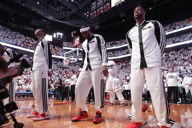 Miami Heat center Chris Bosh (1), left,  forward LeBron James (6), center and  guard Dwyane Wade (3) during the pre-game ceremony in Game 3 in the NBA basketball Eastern Conference finals playoff series against the Indiana Pacers, Saturday, May 24, 2014, in Miami. (AP Photo/Lynne Sladky)