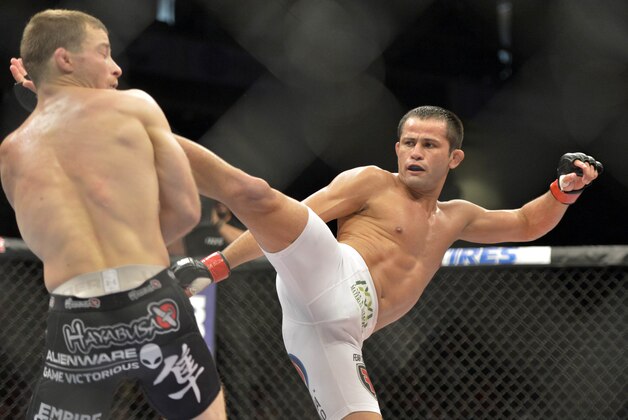 Aug 16, 2014; Bangor, ME, USA; Jussier Formiga (red gloves) fights Zach Makovsky (blue gloves) during a flyweight bout in UFC Fight Night 47 at Cross Insurance Center. Mandatory Credit: Gregory J. Fisher-USA TODAY Sports