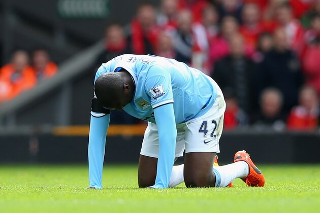 LIVERPOOL, ENGLAND - APRIL 13:  Yaya Toure of Manchester City reacts to an injury during the Barclays Premier League match between Liverpool and Manchester City at Anfield on April 13, 2014 in Liverpool, England.  (Photo by Alex Livesey/Getty Images)