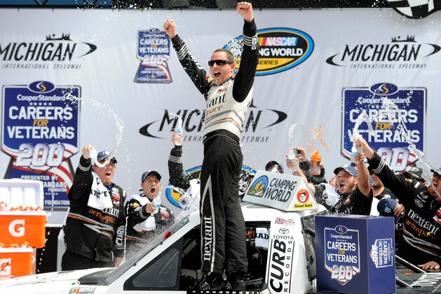 BROOKLYN, MI - AUGUST 16:  Johnny Sauter, driver of the #98 Nextant/Curb Toyota, celebrates in Victory Lane after winning the NASCAR Camping World Truck Series Careers For Veterans 200 at Michigan International Speedway on August 16, 2014 in Brooklyn, Michigan.  (Photo by Jared C. Tilton/Getty Images)