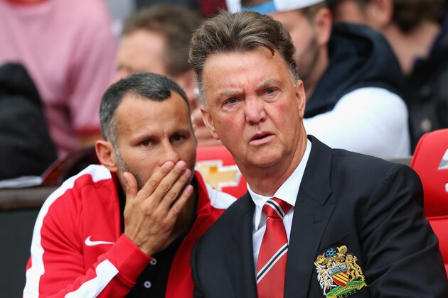 MANCHESTER, ENGLAND - AUGUST 16:  Manchester United Manager Louis van Gaal speaks with Assistant Ryan Giggs (L) prior to the Barclays Premier League match between Manchester United and Swansea City at Old Trafford on August 16, 2014 in Manchester, England.  (Photo by Alex Livesey/Getty Images)