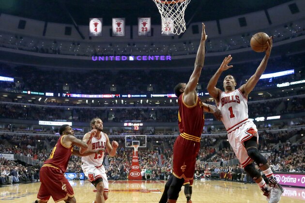 Chicago Bulls guard Derrick Rose (1) shoots over Cleveland Cavaliers center Andrew Bynum as center Joakim Noah (13) and Alonzo Gee look for a rebound during the first half of an NBA basketball game Monday, Nov. 11, 2013, in Chicago. (AP Photo/Charles Rex Arbogast)