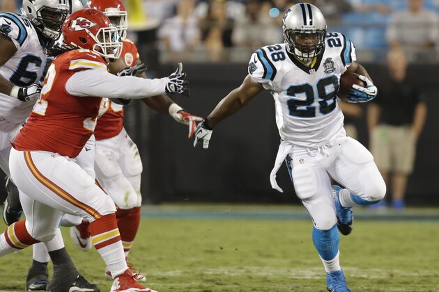 Carolina Panthers' Jonathan Stewart (28) runs past Kansas City Chiefs' Dontari Poe (92) during the first half of a preseason NFL football game in Charlotte, N.C., Sunday, Aug. 17, 2014. (AP Photo/Bob Leverone)