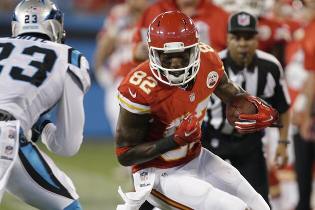 Kansas City Chiefs' Dwayne Bowe (82) runs after a catch as Carolina Panthers' Melvin White (23) closes in during the first half of a preseason NFL football game in Charlotte, N.C., Sunday, Aug. 17, 2014. (AP Photo/Bob Leverone)