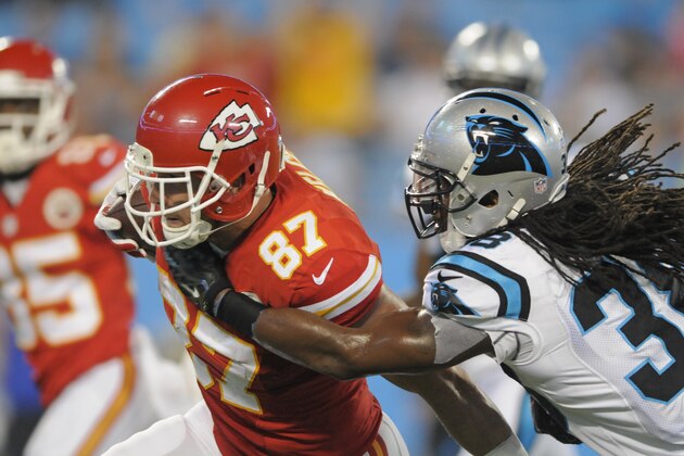 Kansas City Chiefs' Travis Kelce (87) catches a touchdown pass against Carolina Panthers' Robert Lester (38) during the second half of a preseason NFL football game in Charlotte, N.C., Sunday, Aug. 17, 2014. (AP Photo/Mike McCarn)