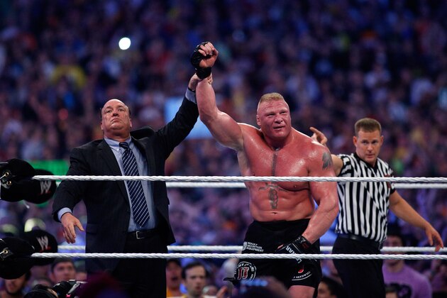 Paul Heyman, left, celebrates with Brock Lesnar after his win over the Undertaker  during Wrestlemania XXX at the Mercedes-Benz Super Dome in New Orleans on Sunday, April 6, 2014. (Jonathan Bachman/AP Images for WWE)