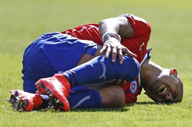 Chile's Arturo Vidal reacts after being tackled during the World Cup round of 16 soccer match between Brazil and Chile at the Mineirao Stadium in Belo Horizonte, Brazil, Saturday, June 28, 2014. (AP Photo/Frank Augstein)