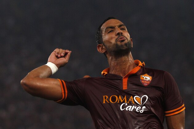 AS Roma's Mehdi Benatia celebrates after scoring during a Serie A soccer match between AS Roma and Bologna at Rome's Olympic stadium, Sunday, Sept. 29, 2013. (AP Photo/Alessandra Tarantino)