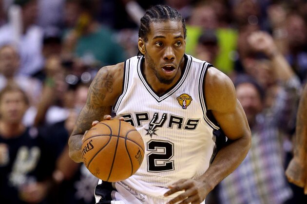 SAN ANTONIO, TX - JUNE 15: Kawhi Leonard #2 of the San Antonio Spurs brings the ball up the floor against the Miami Heat during Game Five of the 2014 NBA Finals at the AT&T Center on June 15, 2014 in San Antonio, Texas. NOTE TO USER: User expressly acknowledges and agrees that, by downloading and or using this photograph, User is consenting to the terms and conditions of the Getty Images License Agreement.  (Photo by Andy Lyons/Getty Images)